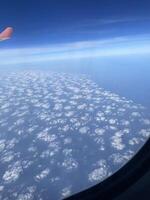 Cloud patterns that can be observed from the window of an airplane during flight travel photo