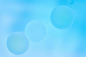 Delicate blue abstract background with numerous air bubbles floating in a soft gradient. photo