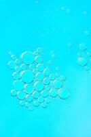 Delicate blue abstract background with numerous air bubbles floating in a soft gradient. Copy space photo