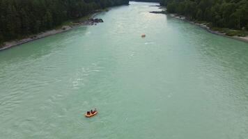Aerial view of people whitewater rafting down the rive video