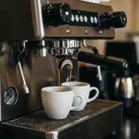 A coffee machine is making two cups of coffee photo