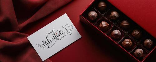 Happy Valentine's Day Message Card with Chocolate Box on Red Fabric Background Top, Used for Banner. photo