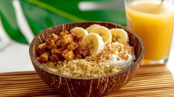 Nourishing quinoa bowl with caramelized apples and bananas served with fresh juice in a tropical setting photo