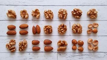 Assorted nuts laid out neatly on a rustic wooden table showcasing walnuts and almonds in creative arrangement photo