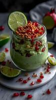 Fresh avocado and pomegranate dessert garnished with lime slices and granola creates a vibrant and healthy treat, perfect for midday snacking or as a light dessert option photo