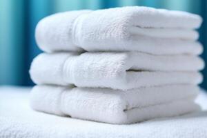 Three white rolled folded fluffy terry towels on the table. Realistic illustration. Light blue background or curtains on the back. photo