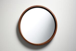 Circle mirror on thin wooden frame isolated on white background. photo