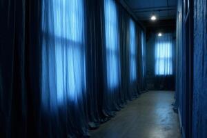 Long corridor with windows and blue curtains to the floor. Two lamps. Parquet floor. photo