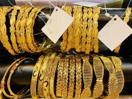 Gold bangles for sale at a market in dubai photo