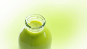 Creamy Avocado Juice in Clear Bottle for Healthy and Nutritious Refreshment. photo