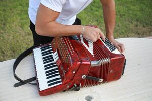 Man Using Tool To Fix And Tune Accordion photo