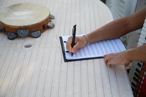 Man Studying Accordion And Watching On The Paper photo