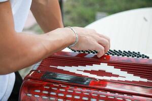 Man Testing All The Buttons Of His Accordion photo