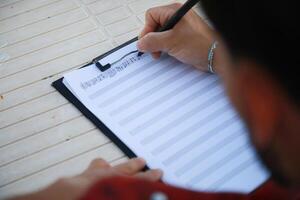 Man Studying Accordion And Watching On The Paper photo