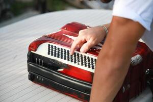 Man Testing All The Buttons Of His Accordion photo