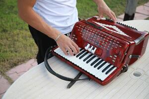 Man Testing All The Buttons Of His Accordion photo