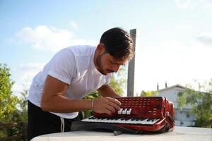 Professional Player Fixing And Tuning The Accordion photo