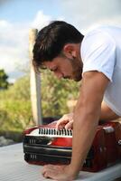Man Testing All The Buttons Of His Accordion photo