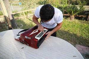Professional Player Fixing And Tuning The Accordion photo