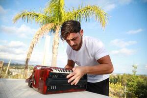 Man Testing All The Buttons Of His Accordion photo