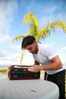 Man Testing All The Buttons Of His Accordion photo