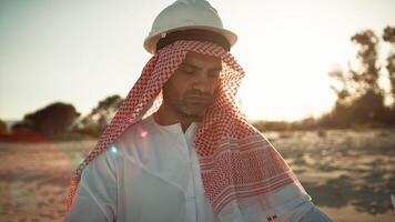 Sheik With Safety Helmet Reading The Project Map photo