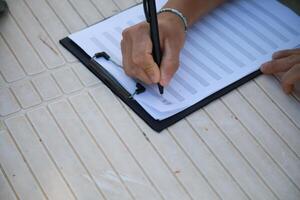 Man Studying Accordion And Watching On The Paper photo