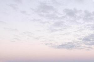 Background with small clouds on sunset sky. Nightfall is on. photo