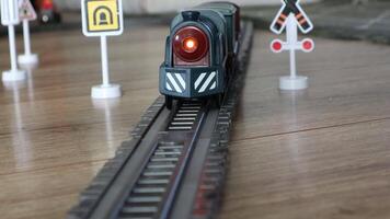 A Model Train running on a Track featuring Signals along with various Rail Safety Signs video