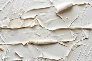 Thick white paint creating abstract texture on canvas photo