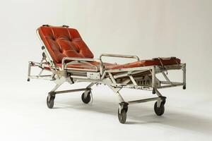 Old empty stretcher standing in a white room photo