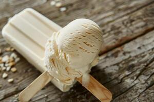 Scoop of vanilla ice cream melting on a popsicle on a wooden table photo