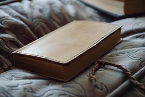 Leather bound notebook resting on soft blanket in cozy setting photo