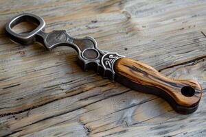 Unique push dagger with wooden handle resting on wooden surface photo