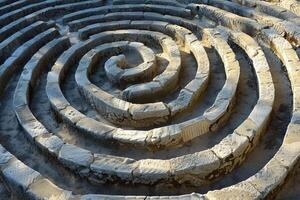 Concentric stone circles forming intricate spiral labyrinth in park setting photo