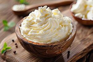 Mascarpone cheese cream in wooden bowl on rustic table photo