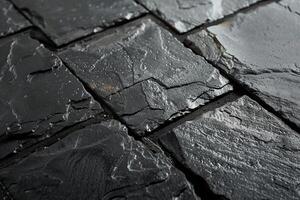 Wet black slate tiles creating textured surface background photo