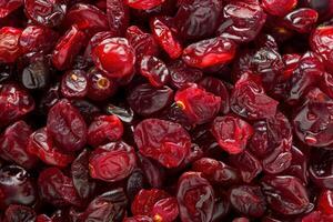 Dried cranberries filling the frame creating a vibrant red background photo