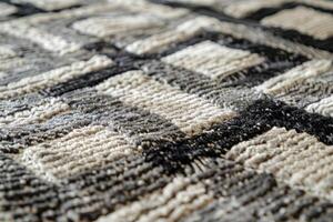 Close up view of intricate weaving pattern on textured carpet in shades of gray and beige photo