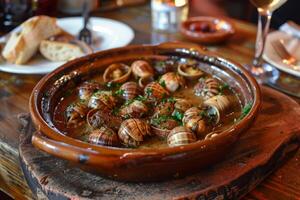 Delicious cooked snails with parsley and sauce in rustic restaurant setting photo