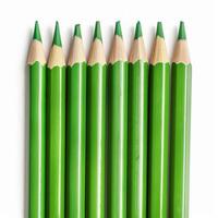 Row of unsharpened green colored pencils forming a pattern photo