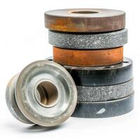 Grinding wheels forming a stack with one leaning on top on white background photo