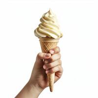 Hand holding delicious soft serve vanilla ricotta ice cream cone photo