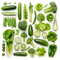 Variety of fresh green vegetables arranged on white background photo