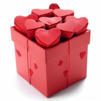 Red cardboard box overflowing with velvet hearts on white background photo