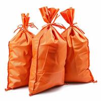 Three orange sacks tied with ribbon knots standing on white background photo