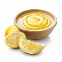 Lemon curd in a terracotta bowl with fresh lemons and lemon slices on white background photo