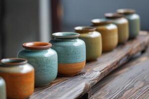 Ceramic vases displayed on rustic wooden shelf, showcasing craftsmanship photo