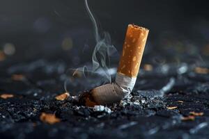 Smoldering cigarette butt resting on burned surface symbolizing smoking hazards photo