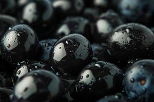 Fresh black olives with water droplets creating a glossy texture photo